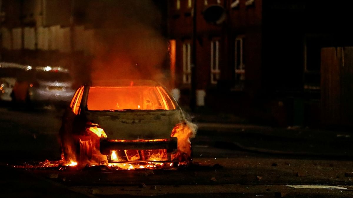 A burning car is pictured during a protest in the Loyalist Tigers Bay Area of Belfast, Northern Ireland. Credit: Reuters.
