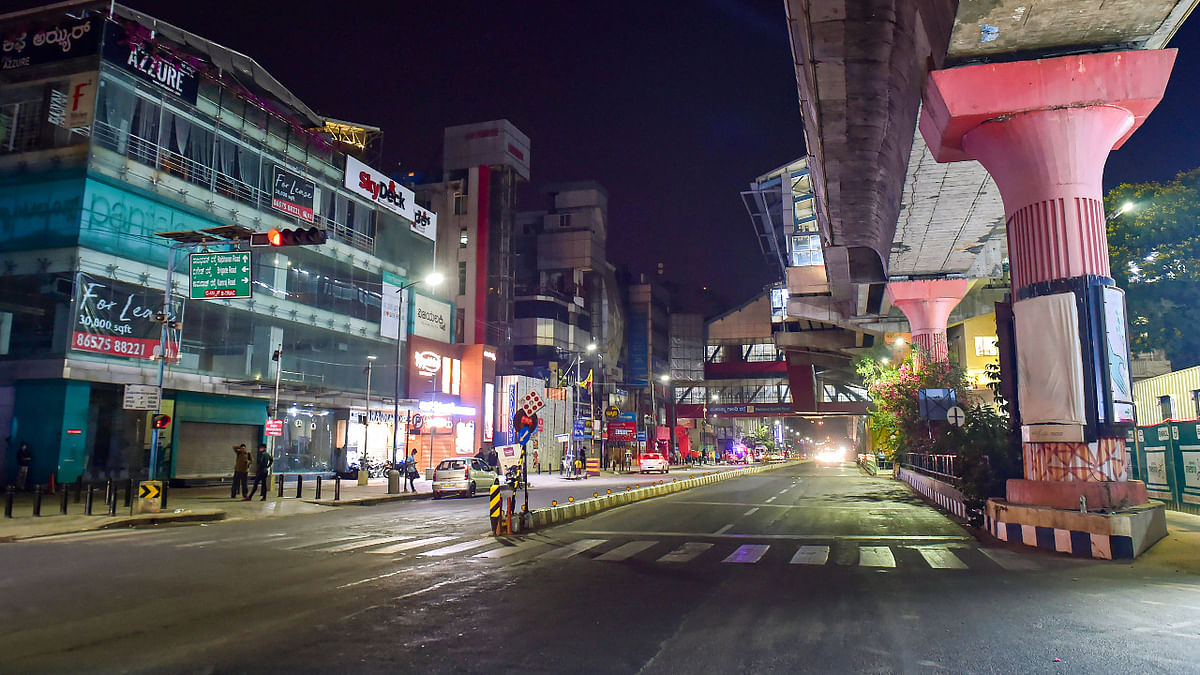 An otherwise busy M G Road looks deserted on the first night of the Corona Curfew in Bengauru and other cities of Karnataka. Credit: PTI Photo