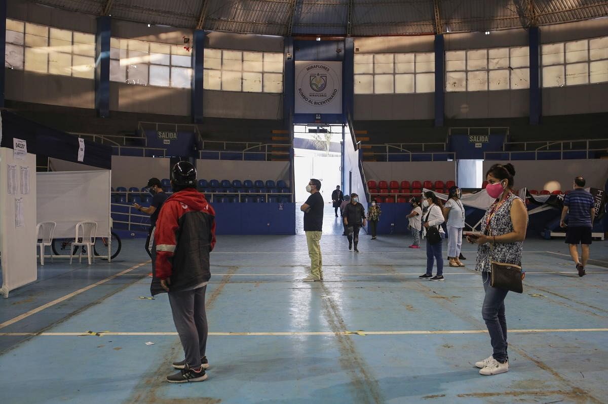 Voters wait to cast their ballots for the presidential and parliamentary elections, at a polling station in Lima, Peru. Credit: Reuters Photo