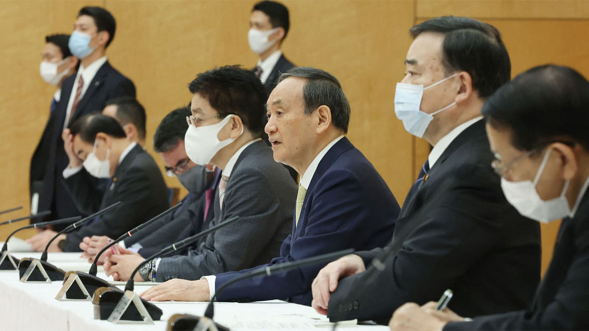 Japan's Prime Minister Yoshihide Suga (C) speaks at a cabinet meeting at the prime minister's office in Tokyo. Japan's government on Tuesday approved a plan to release more than one million tonnes of treated water from the stricken Fukushima nuclear plant into the ocean, in a controversial decision that follows years of debate. Credit: AFP Photo