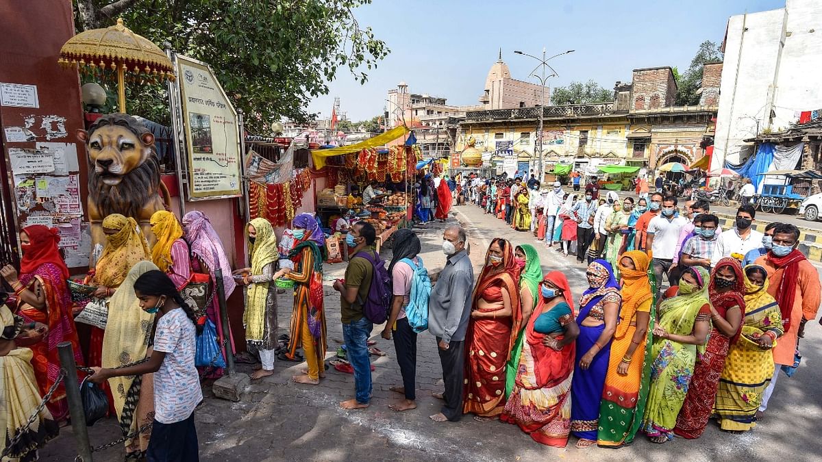 Devotees stand in a queue to offer prayers at Alopi Devi Temple on the first day of Navratri celebrations, during the ongoing coronavirus pandemic, in Prayagraj.