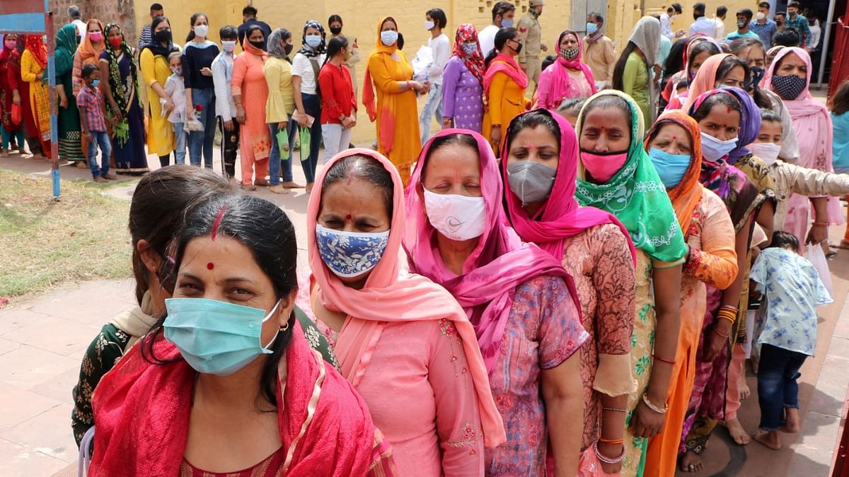 Devotees, wearing face masks, wait in queues to offer prayers at Kali Mata Temple on the first day of Navratri celebrations, during the ongoing coronavirus pandemic, in Jammu.