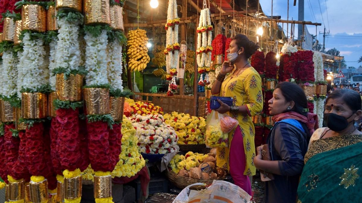 People shopped for flower garlands before ‘Ugadi’ in Bangalore. People's spirits were high despite a surge in Covid-19 cases in Karnataka, especially Bengaluru urban. Credit: AFP Photo