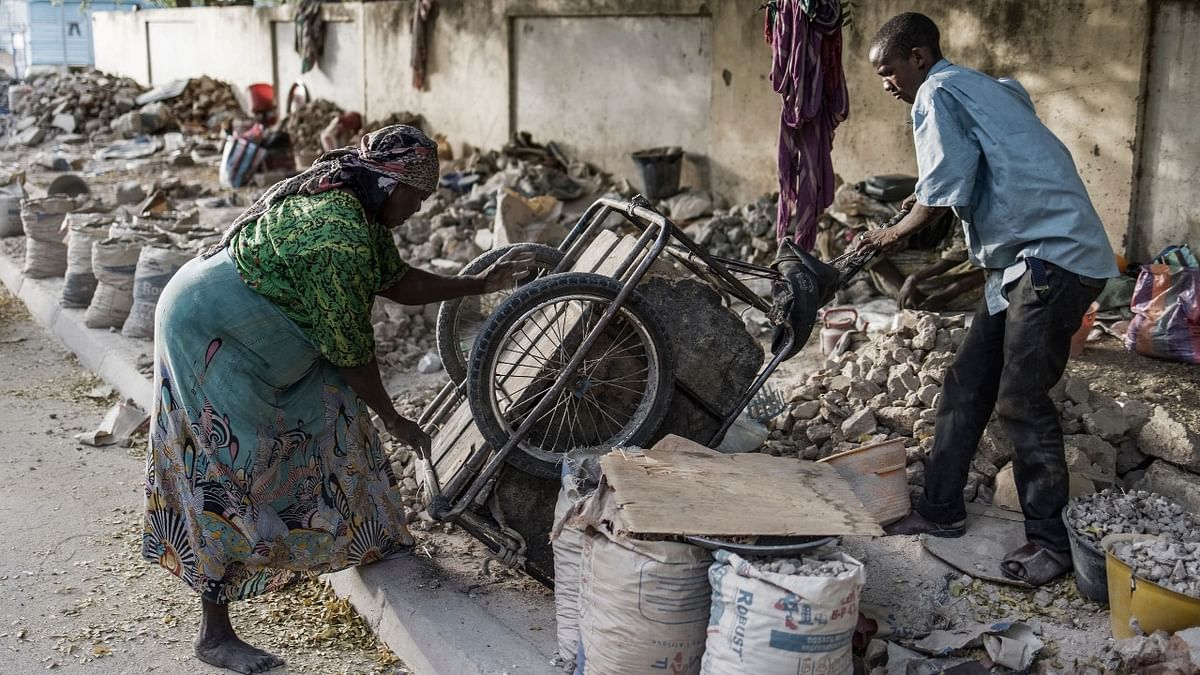 A cart is toppled a shaken to set loose every little stone by a gravel crusher at a site near the Cite International des Affaires in N'Djamena, on April 12, 2021. Credit: AFP photo