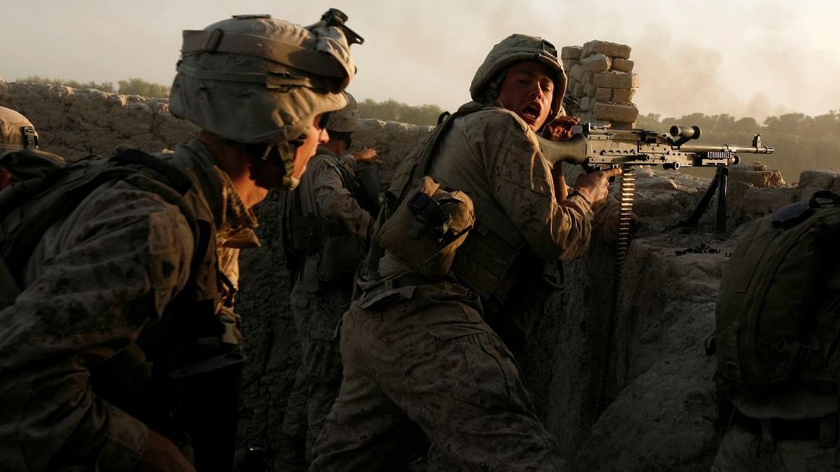 US Marines fire during a Taliban ambush as they carry out an operation to clear an area in Helmand province, Afghanistan, October 9, 2009. Credit: Reuters file photo