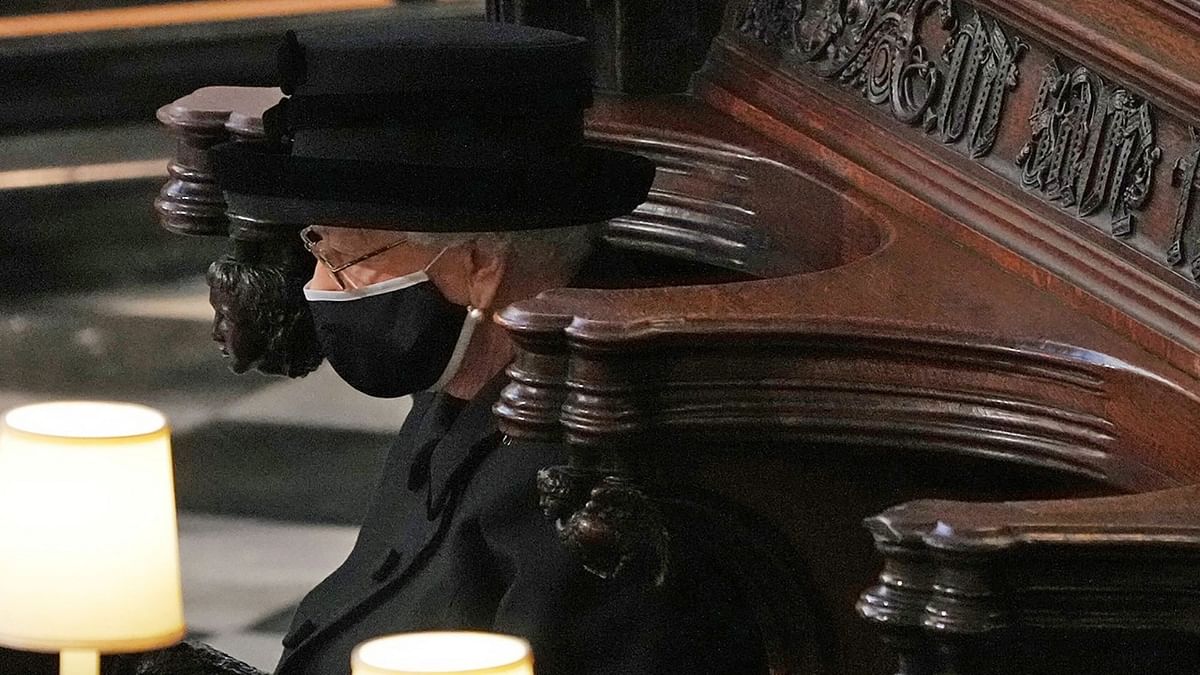 Queen Elizabeth, dressed in black and in a white trimmed black mask, was alone at St George's Chapel following Covid-19 protocols. Credit: AFP Photo