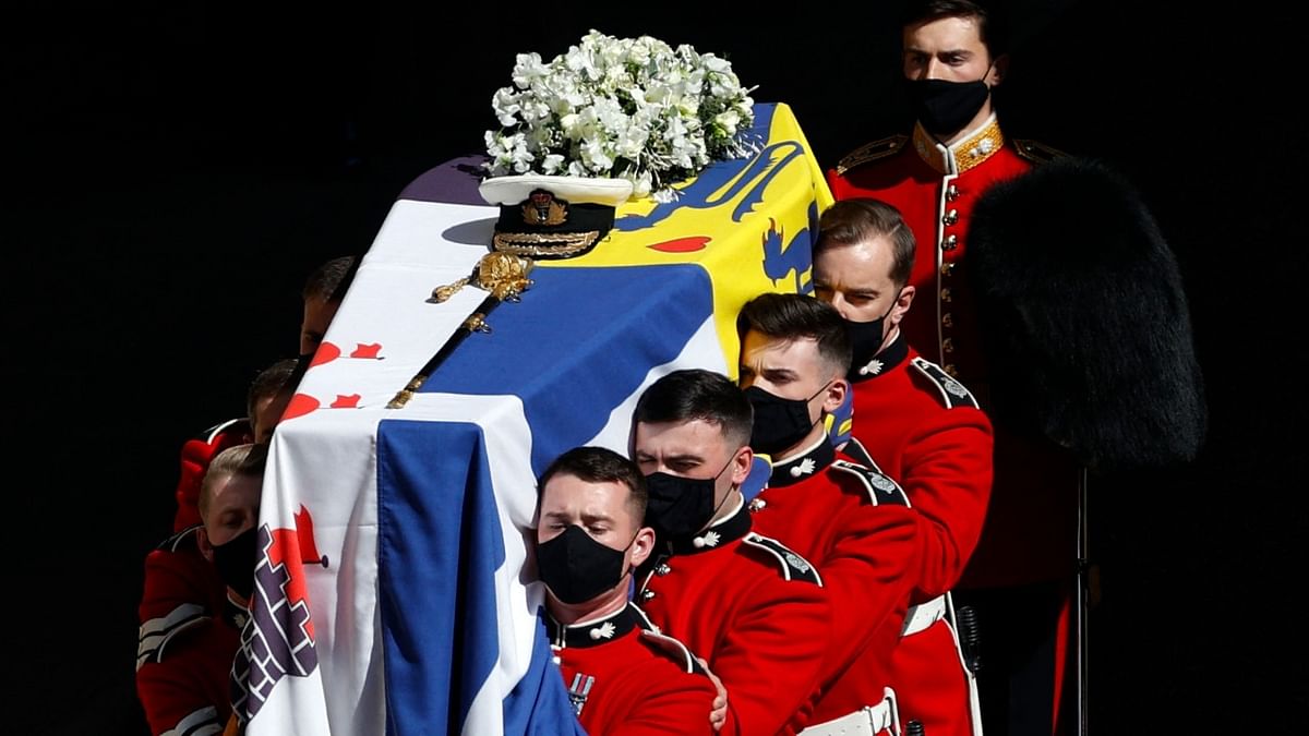 His naval cap and sword were laid on top of the coffin, which was covered with the Duke of Edinburgh's personal standard alongside white roses and lilies. Credit: AFP Photo