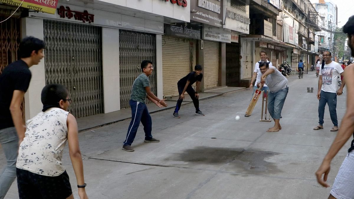 Nagpur |  Children play cricket, as shops remain closed during weekend lockdown imposed by Maharashtra Government. Credit: PTI Photo