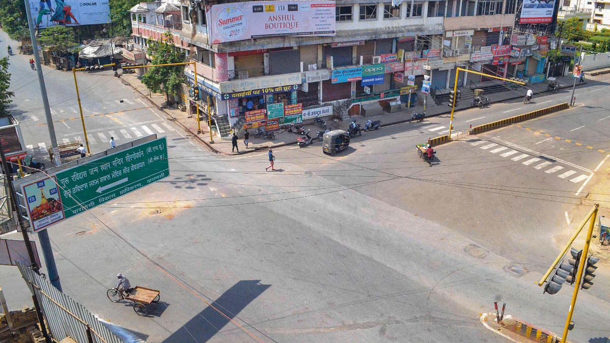 Varanasi | Streets wore a deserted look during the weekend lockdown imposed in many parts of Uttar Pradesh due to a surge in Covid-19 cases. UP CM Yogi Adityanath has also tested positive for the virus and is isolating. Credit: PTI Photo