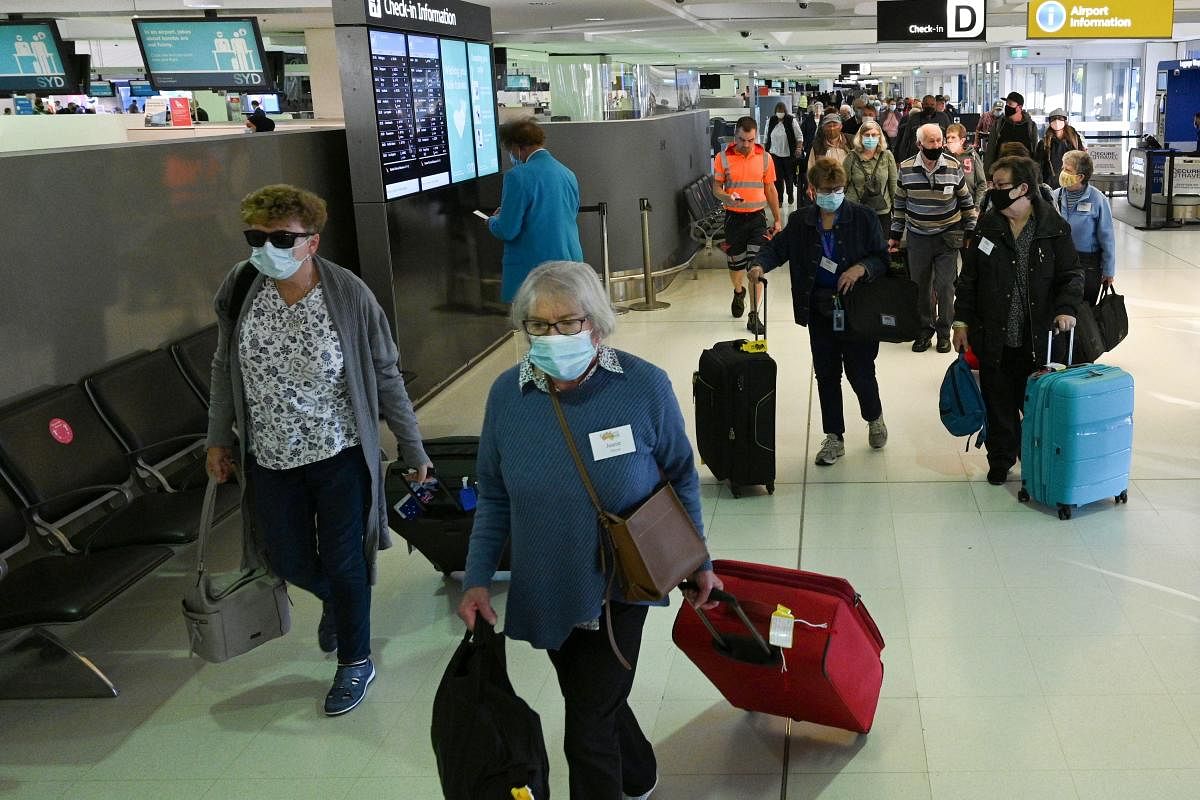 Travellers proceed to the check-in counters for New Zealand flights at Sydney International Airport on April 19, 2021, as Australia and New Zealand opened a trans-Tasman quarantine-free travel bubble. Credit: AFP photo.