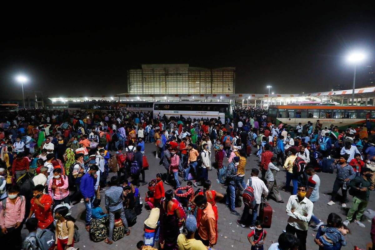 A large number of migrant workers thronged bus terminals and railway stations fearing that the six-day lockdown may get extended. Credit : Reuters Photo