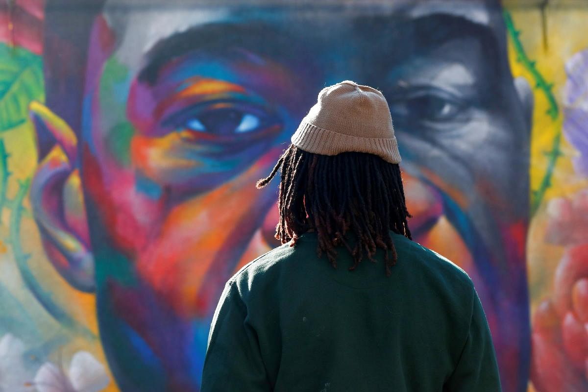 A person pays his respect at a mural of George Floyd after the verdict in the trial of former Minneapolis police officer Derek Chauvin, found guilty of the death of Floyd, in Denver, Colorado. Credit: Reuters photo.