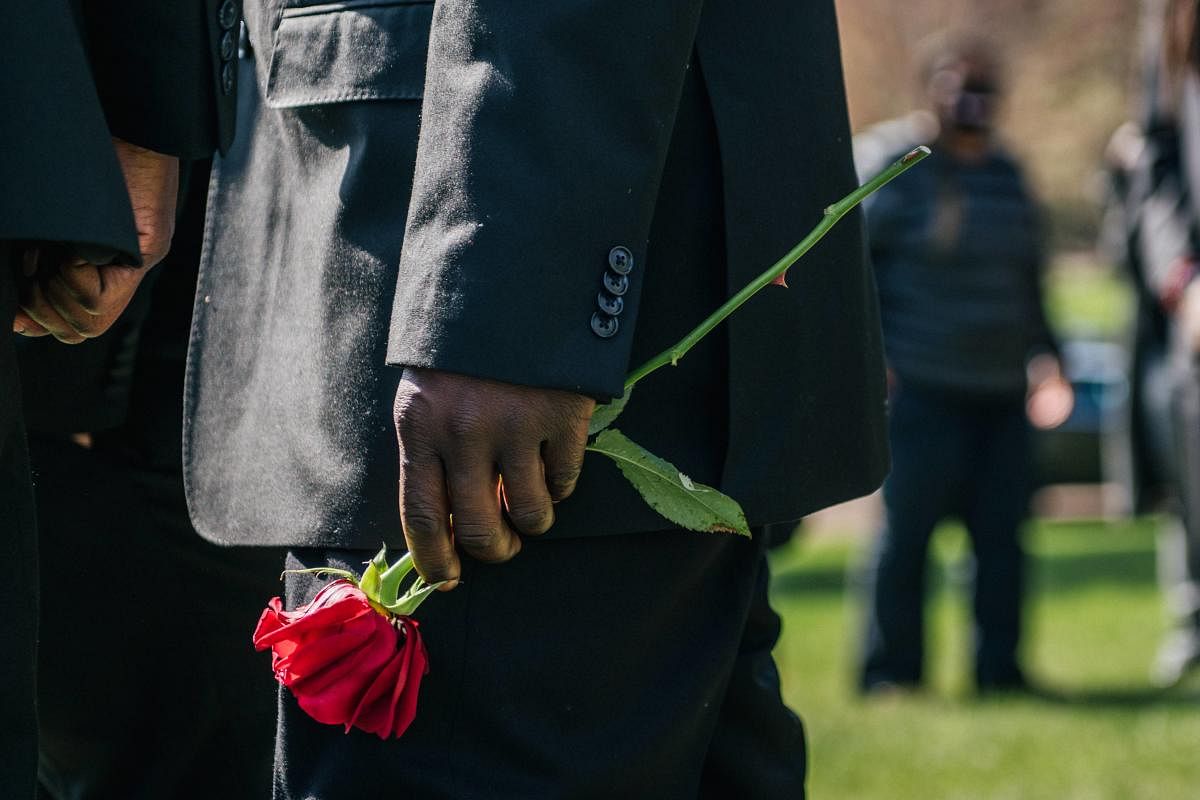 A man holds a rose during a dove releasing at Daunte Wright's funeral on April 22, 2021 in Minneapolis, Minnesota. Credit: AFP photo.