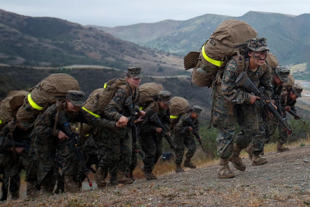Female recruits from US Marine Corps Recruit Depot San Diego, Lima Company, participate in the final leg of the gruelling crucible training climbing the final hill to become the first-ever women Marines trained at Camp Pendleton, California. Credit: Reuters photo.