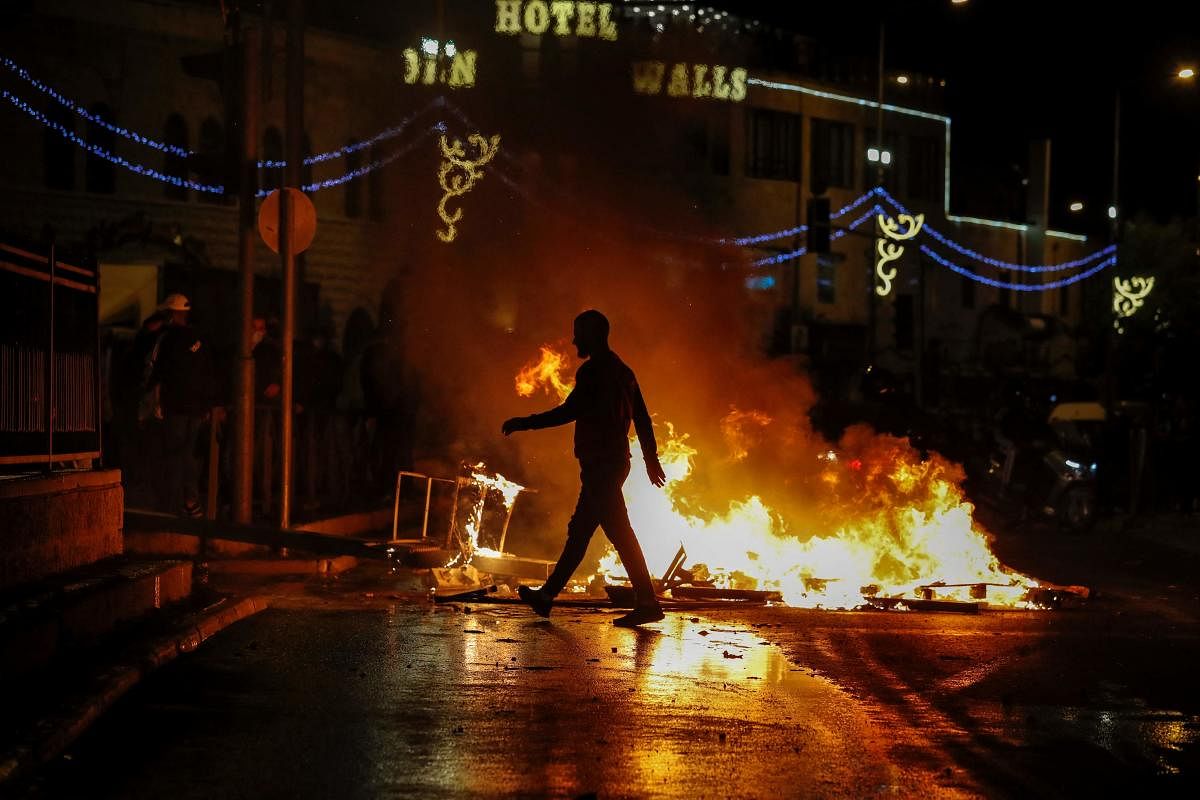 Streets are set ablaze as members of the Israeli security forces deploy during clashes with Palestinian protesters outside the Damascus Gate in Jerusalem's Old City. Credit: AFP photo.