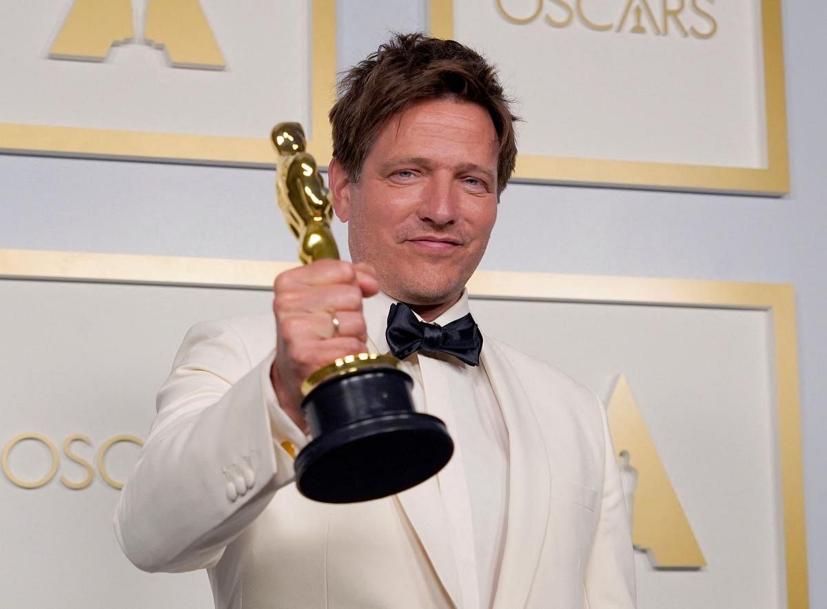 Danish director Thomas Vinterberg poses with the award for best international feature film for