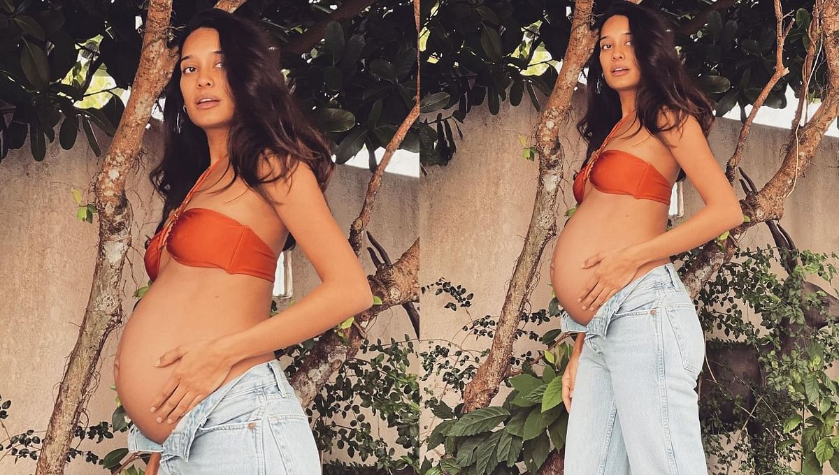 Be it ethnic or western, the diva surely knows how to ace the fashion game well. In this photo, Lisa flaunts her baby bump in an orange halter neck bikini top and jeans.