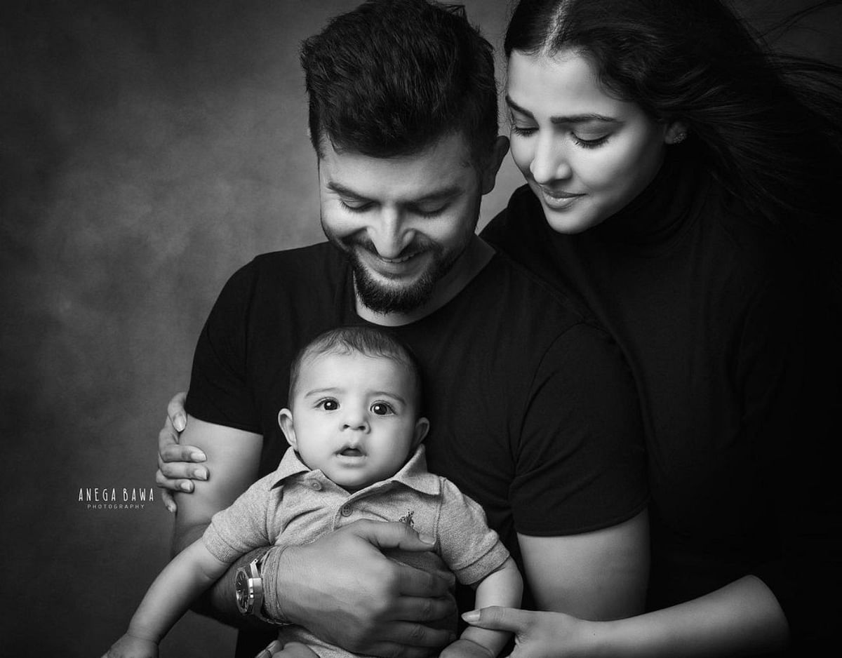 An adorable monochrome picture of Cricketer Suresh Raina and Priyanka Chaudhary Raina with their kid. Credit: Instagram/sureshraina3