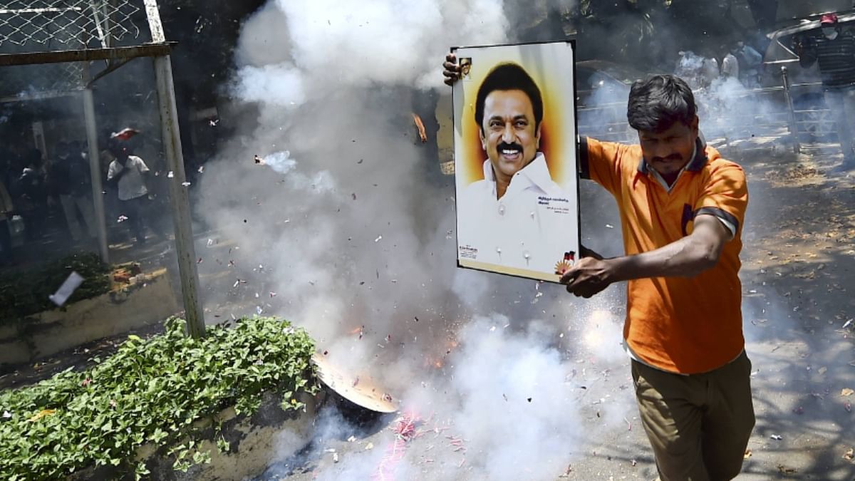 Party workers celebrate DMK's performance in the Tamil Nadu elections with firecrackers.