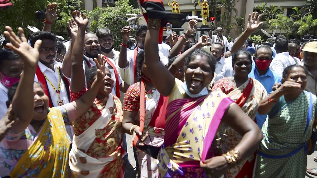 DMK Party workers dance as they celebrate the party's performance in the Tamil Nadu elections.