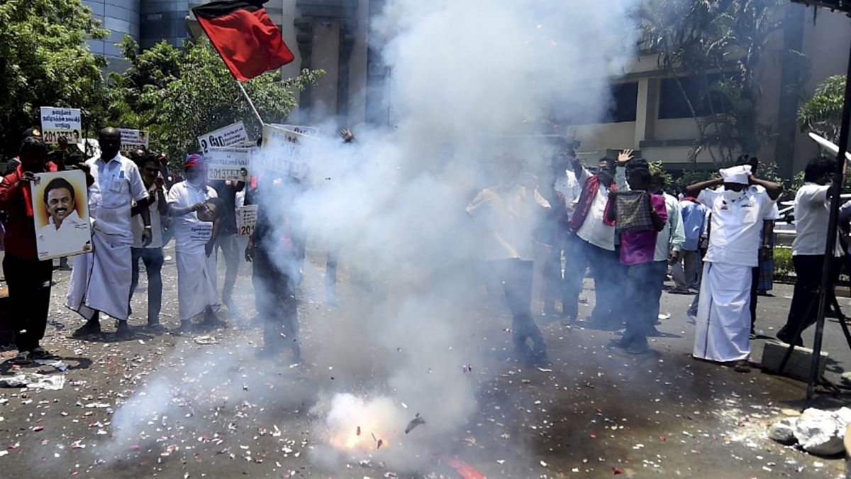 Party workers celebrate the DMK's performance in the Tamil Nadu elections by bursting firecrackers.