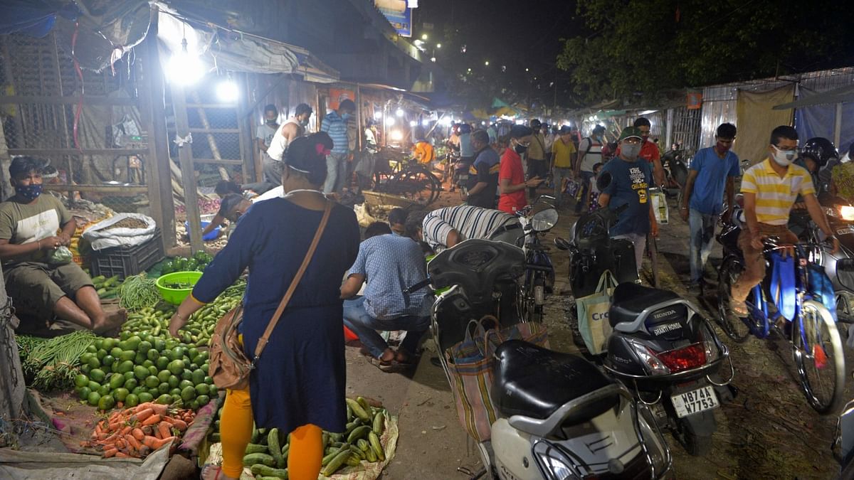 People crowd at a vegetable market after the state government announced restrictions to curb the spread of the Covid-19 coronavirus in Siliguri. Credit: AFP Photo
