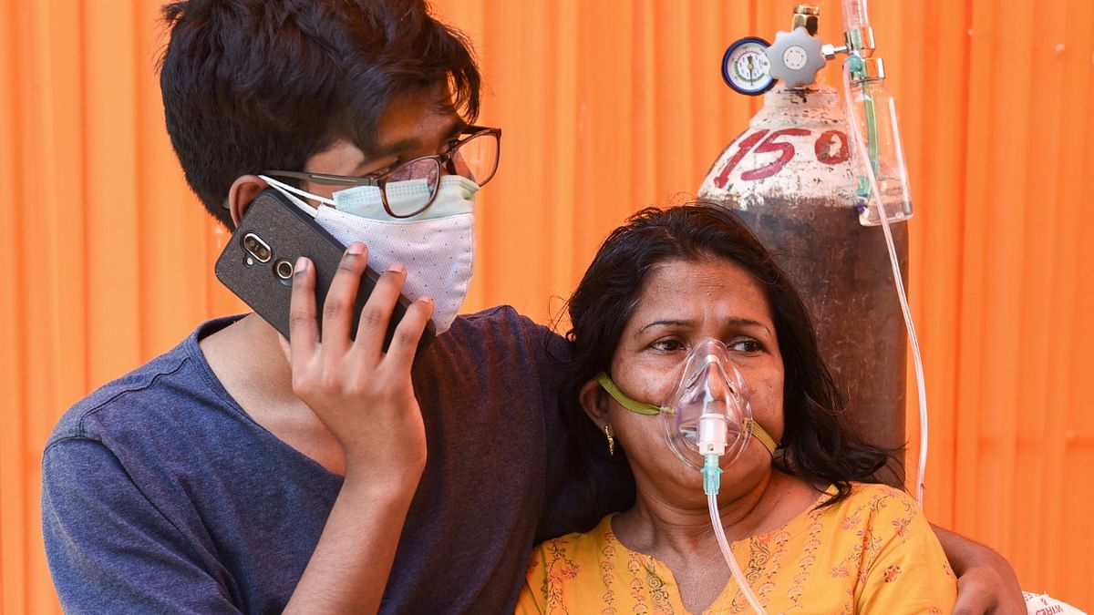 Covid-19 patient uses an oxygen cylinder from an NGO Hemkunt Foundation, which is offering free oxygen cylinders for Covid-19 patients, at Sector 42, in Gurugram.