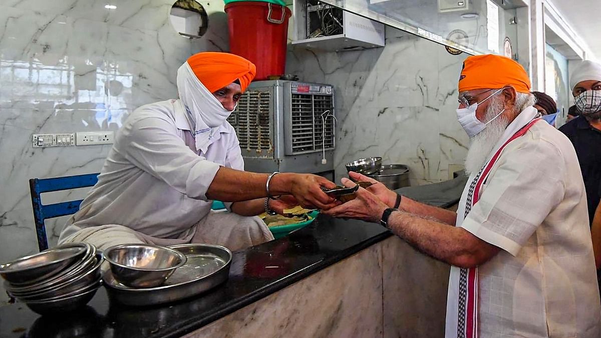 Prime Minister Narendra Modi receiving 'prasad'. Credit: PIB