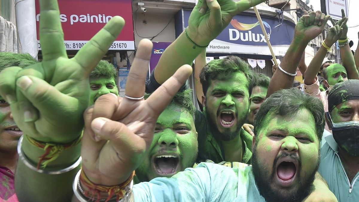 TMC activists celebrate their party's winning trend during the West Bengal State Assembly polls, in Kolkata. Credit: PTI