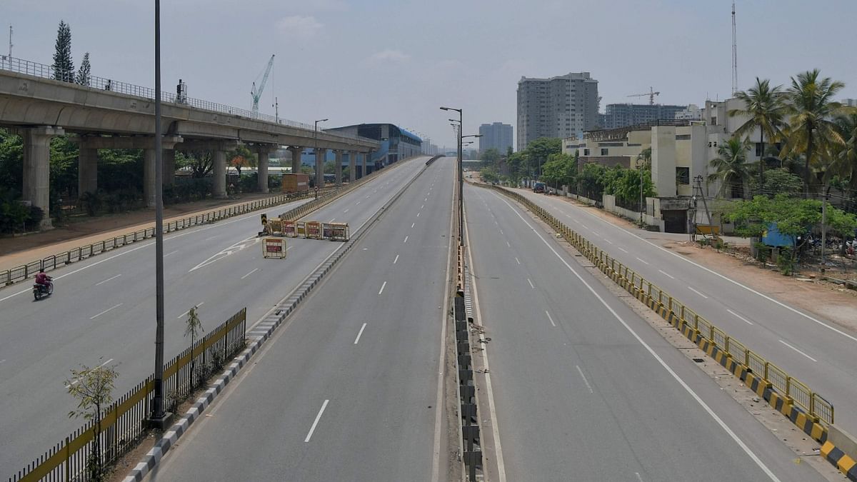 A partially deserted road is pictured during the weekend lockdown imposed as a preventive measure against the spread of the Covid-19 coronavirus in Bengaluru. Credit: AFP