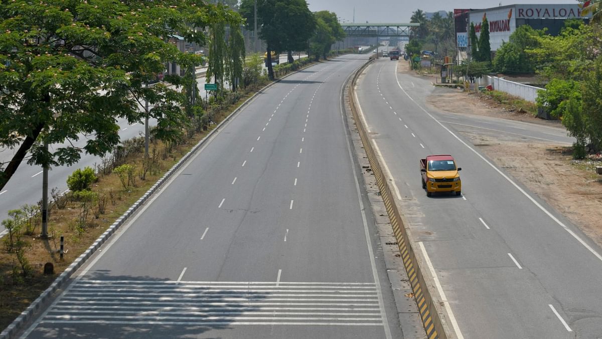 A partially deserted national highway is pictured during the weekend lockdown imposed as a preventive measure against the spread of the Covid-19 coronavirus in Bengaluru. Credit: AFP