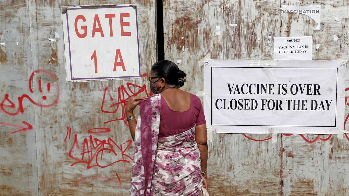A woman, who came to receive a dose of a coronavirus disease (COVID-19) vaccine, returns after the vaccination centre was closed due to unavailability of the supply of COVID-19 vaccine, in Mumbai. Credit: Reuters
