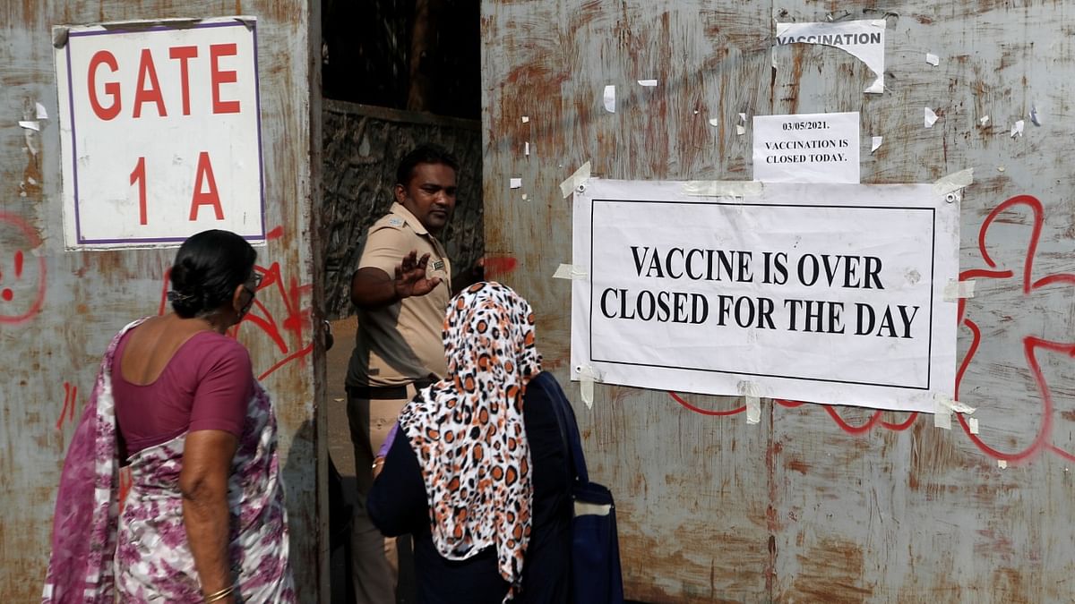 A policeman asks people to leave as vaccination centre runs out of the supply of COVID-19 vaccine, in Mumbai. Credit: Reuters