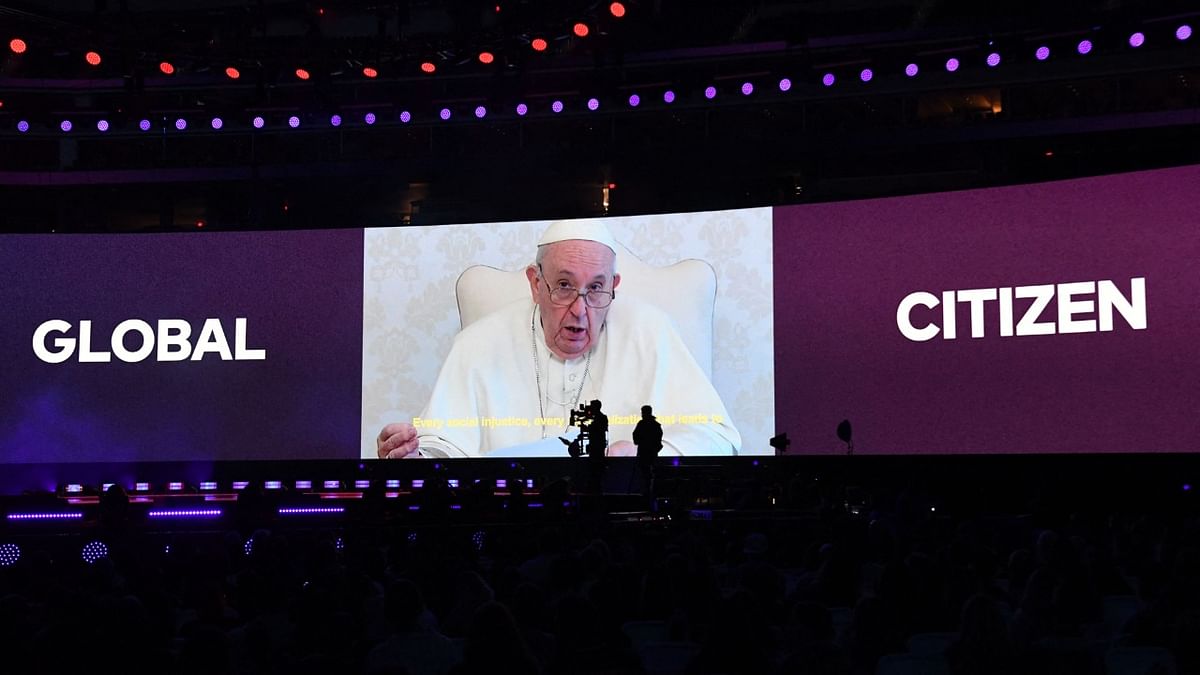 Pope Francis is seen on a screen during the taping of the