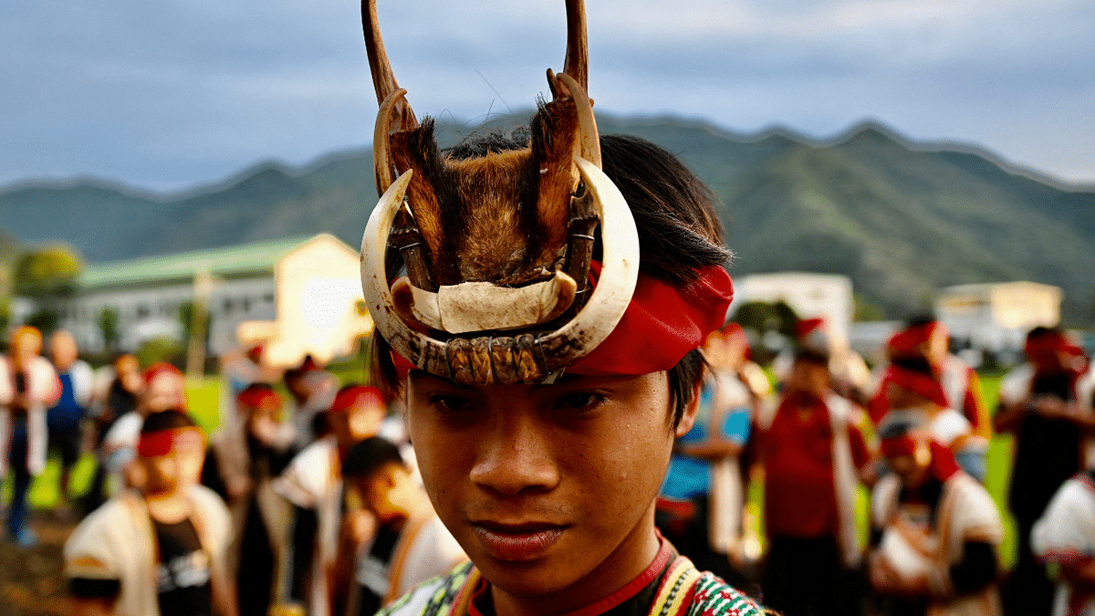 A young Indigenous priest (C) surrounded by his clansmen during a festival at a village in Chishang township, Taitung county. Credit: AFP Photo