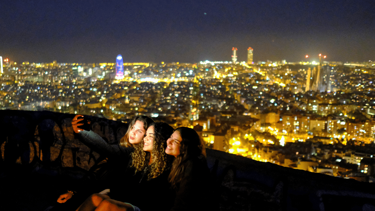 Tourists take a selfie at a lookout point, with a view of the city of Barcelona in the background, as the state of emergency decreed by the Spanish Government to prevent the spread of Covid-19 is due to end on Sunday. Credit: Reuters Photo