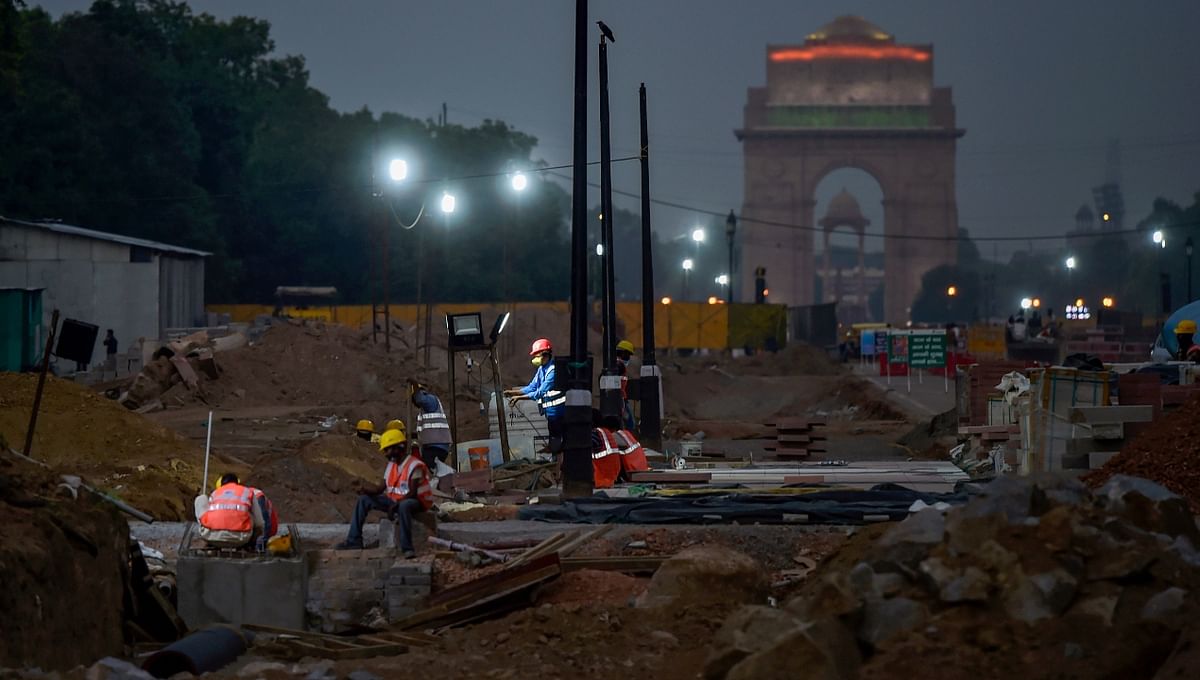 Construction workers are seen working till late in the evening at Rajpath in New Delhi.