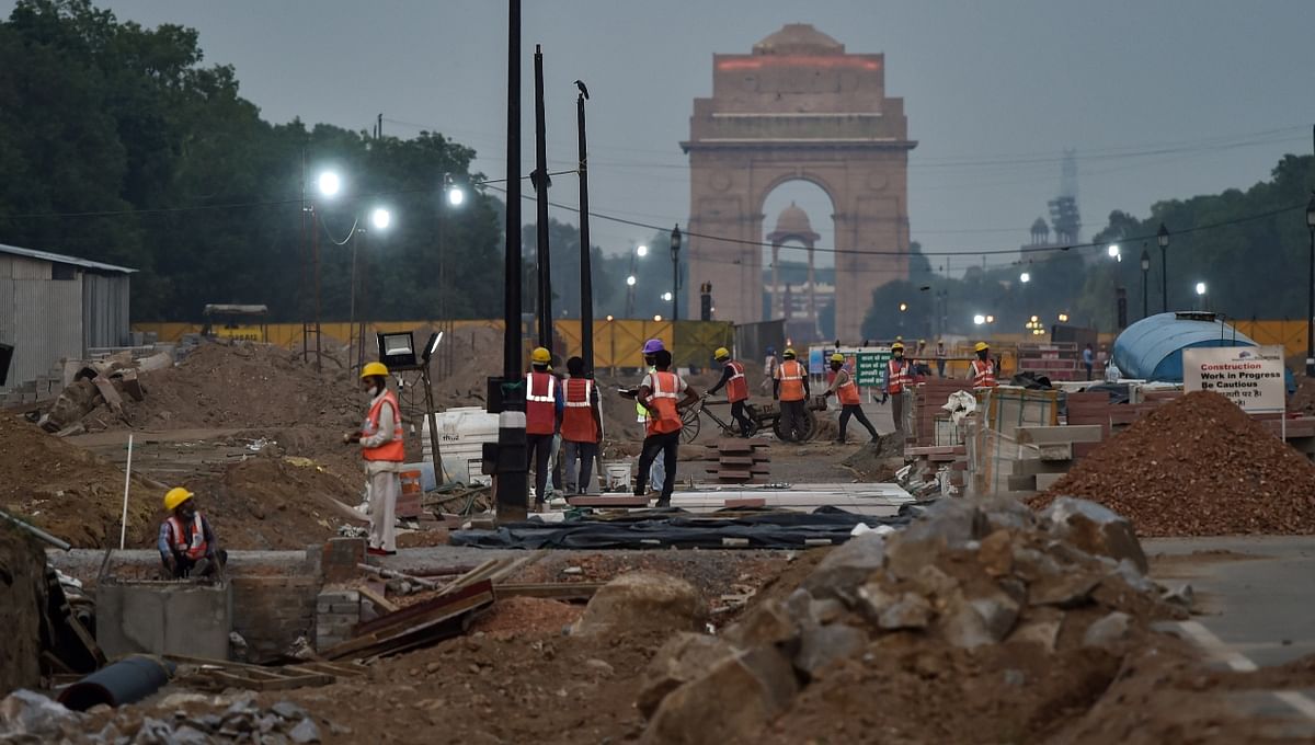 Construction workers are seen working at Rajpath in New Delhi.