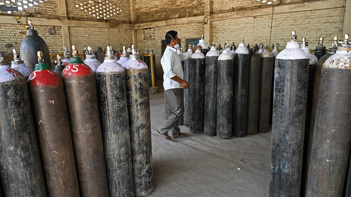 An employee checks medical oxygen cylinders for the Covid-19 coronavirus patients at Kalinga oxygen refilling centre in Moradabad. Credit: AFP Photo