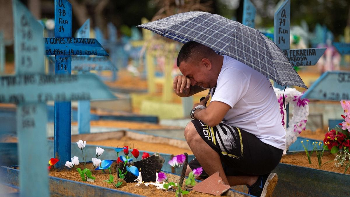 A man cries by a grave at the Nossa Senhora Aparecida cemetery on Mothers Day, in Manaus, Amazonas State, Brazil. Credit: AFP Photo