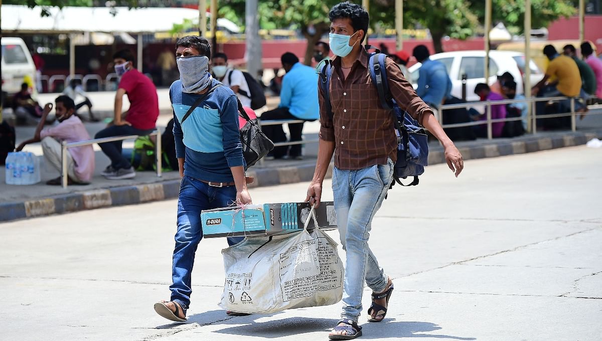 Workers leave Bengaluru before the statewide lockdown imposed to combat coronavirus, in Karnataka.