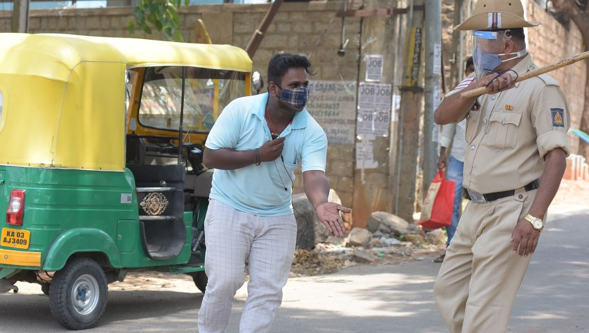 A police officer wields his baton against a man as a punishment for breaking the lockdown rules in Bengaluru.