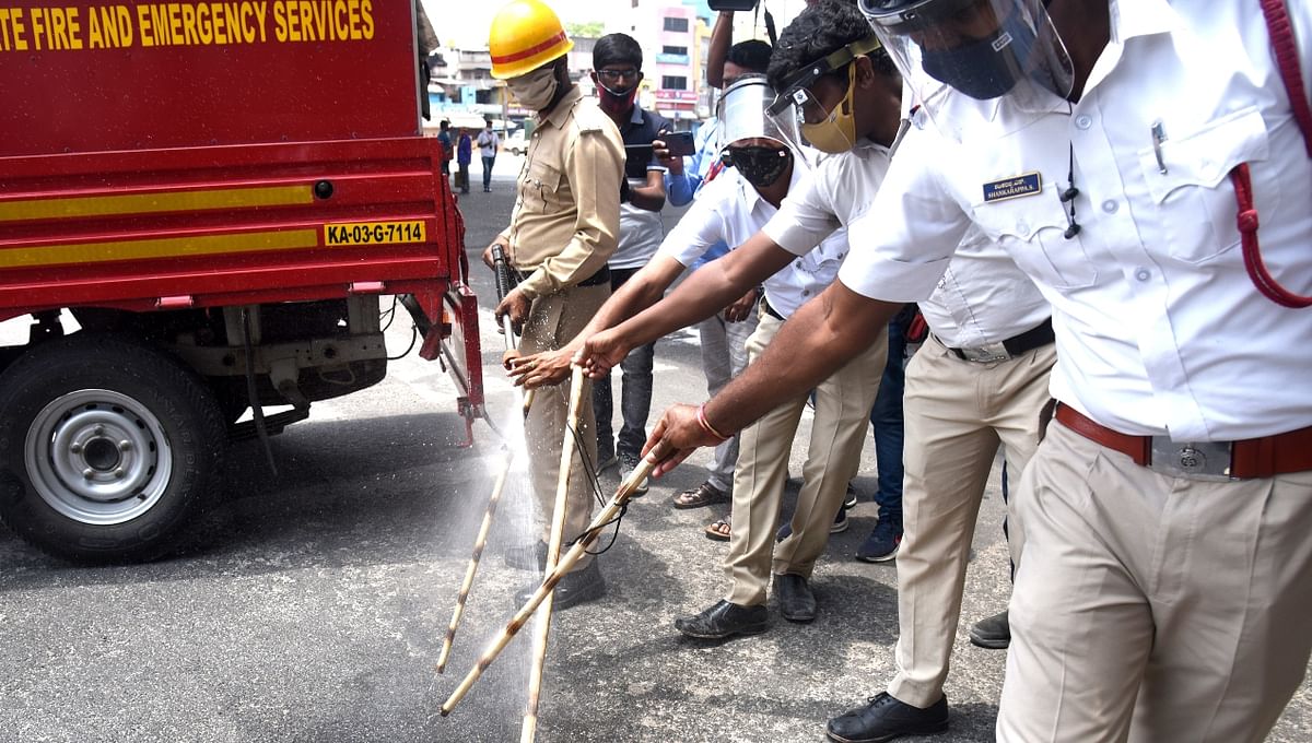 Policemen are seen sanitising the lathis while keeping a strict vigil in Bengaluru.