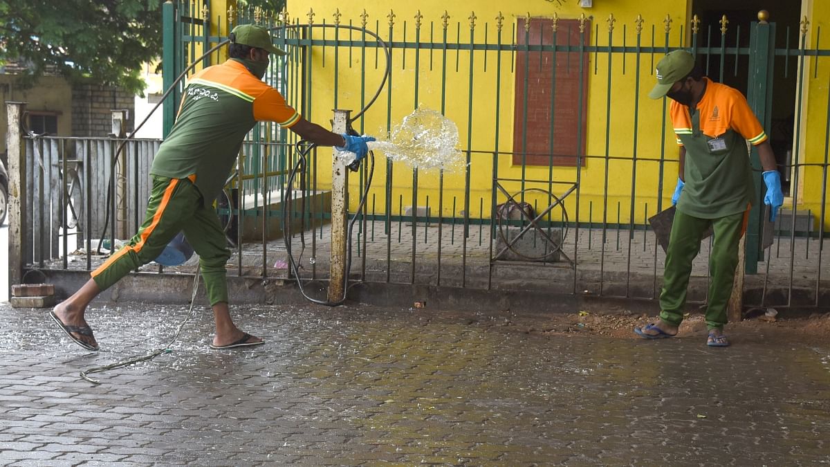 BBMP Pourakarmikas sanitising and cleaning streets near Dairy circle.