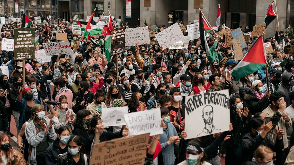 Protesters demanding an end to Israeli aggression against Palestine march in the street in Midtown Manhattan in new York. Credit: AFP Photo
