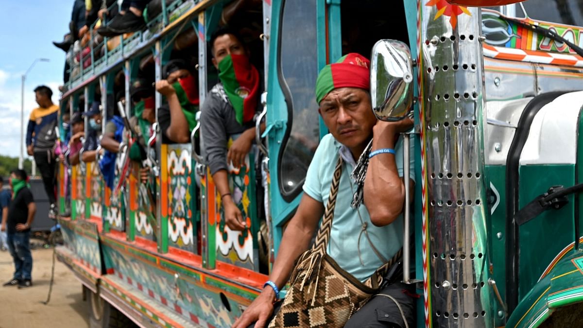 Colombian indigenous people are transported on a 'chiva' (local bus) during a new protest against the government held in the framework of a national strike triggered by a now abandoned tax reform, on a Panamerican way in Cali, Colombia. Credit: AFP Photo