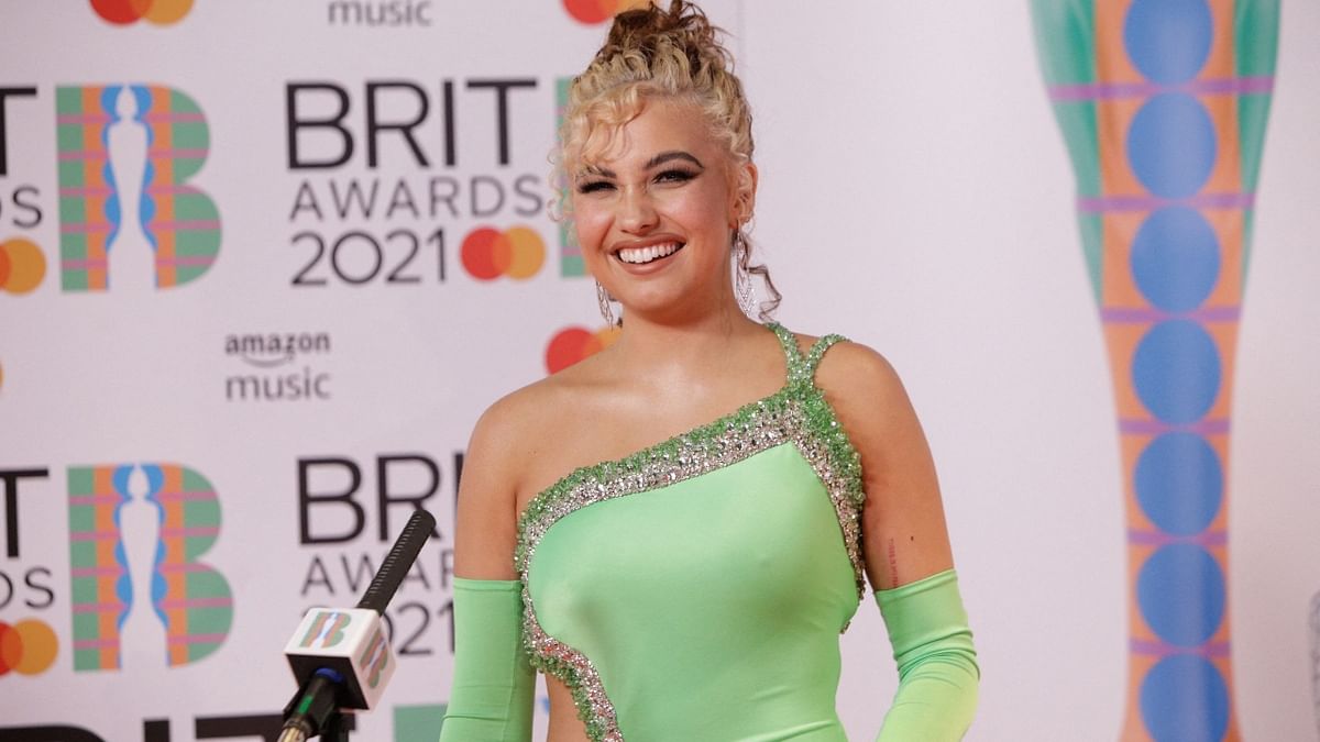 British singer-songwriter Mabel smiles on the red carpet on arrival for the BRIT Awards 2021 in London. Credit: AFP Photo