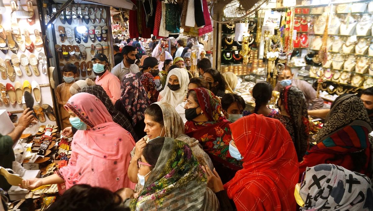 Women shop for the upcoming Eid al-Fitr holiday that marks the end of the Muslim holy fasting month of Ramadan, at a market in Lahore, Pakistan. Credit: PTI Photo