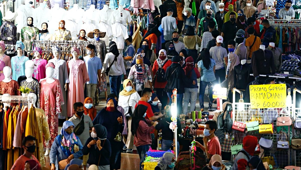 People wearing protective face masks shopping in Tanah Abang textile market ahead of Eid al-Fitr festival amid Covid-19 in Jakarta, Indonesia. Credit: Reuters Photo