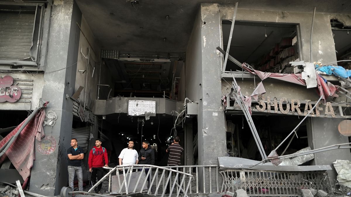 Palestinians view the damage in the aftermath of Israeli air strikes. Credit: Reuters Photo